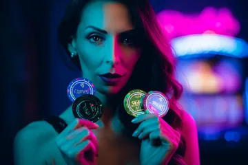A woman smiling by bright slot machines showing lucky symbols, showcasing the exciting slot offerings at AMJILI.